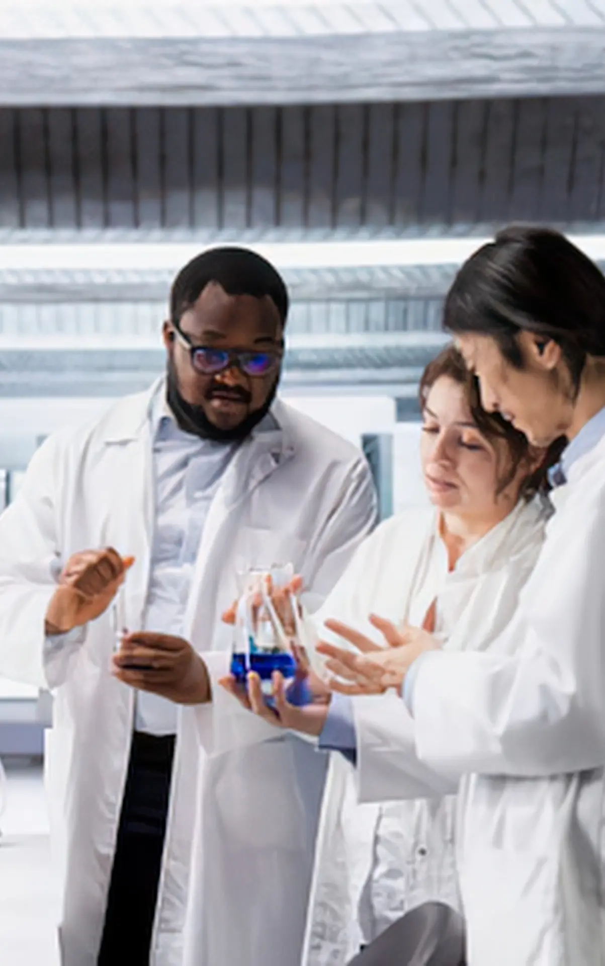 Research scientists examining a sample together in a laboratory.